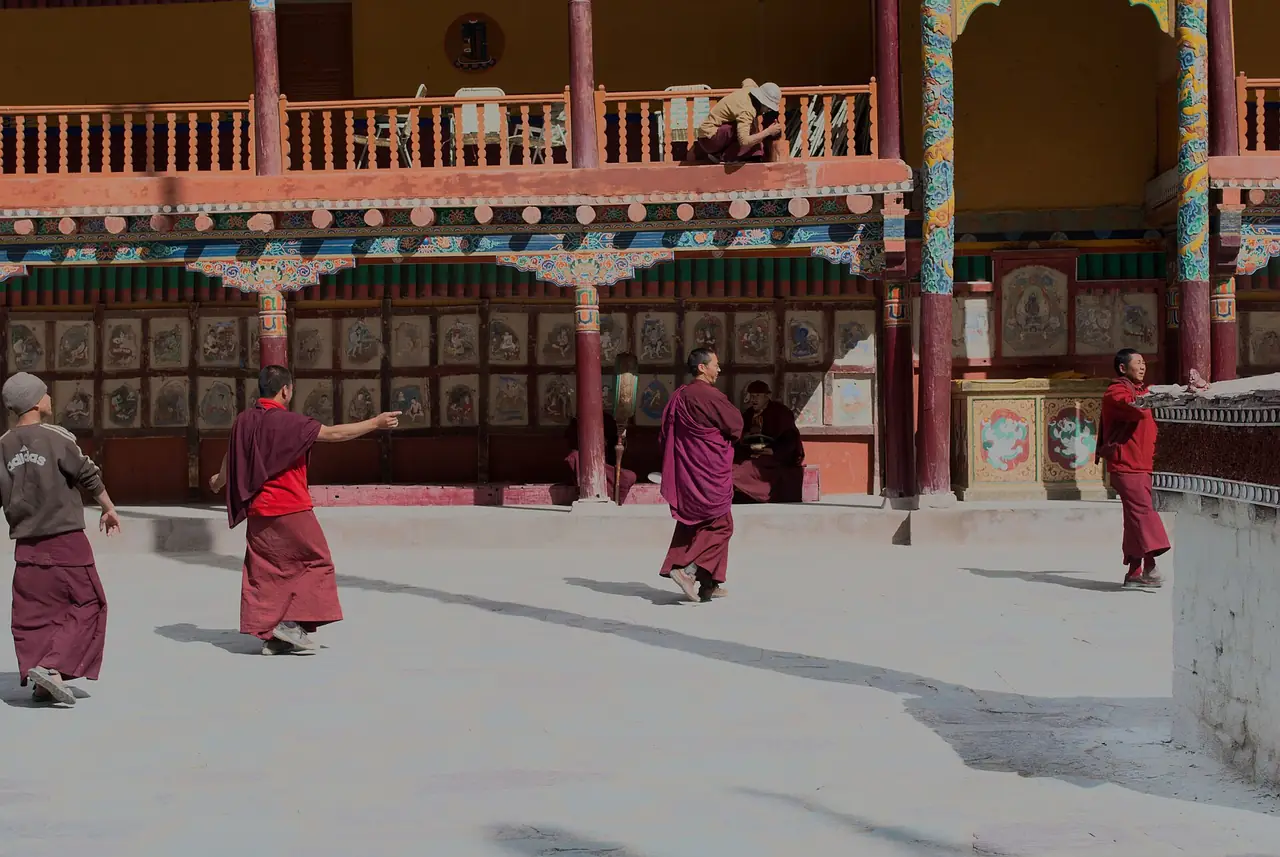 Monks crossing a monastery courtyard in Ladakh