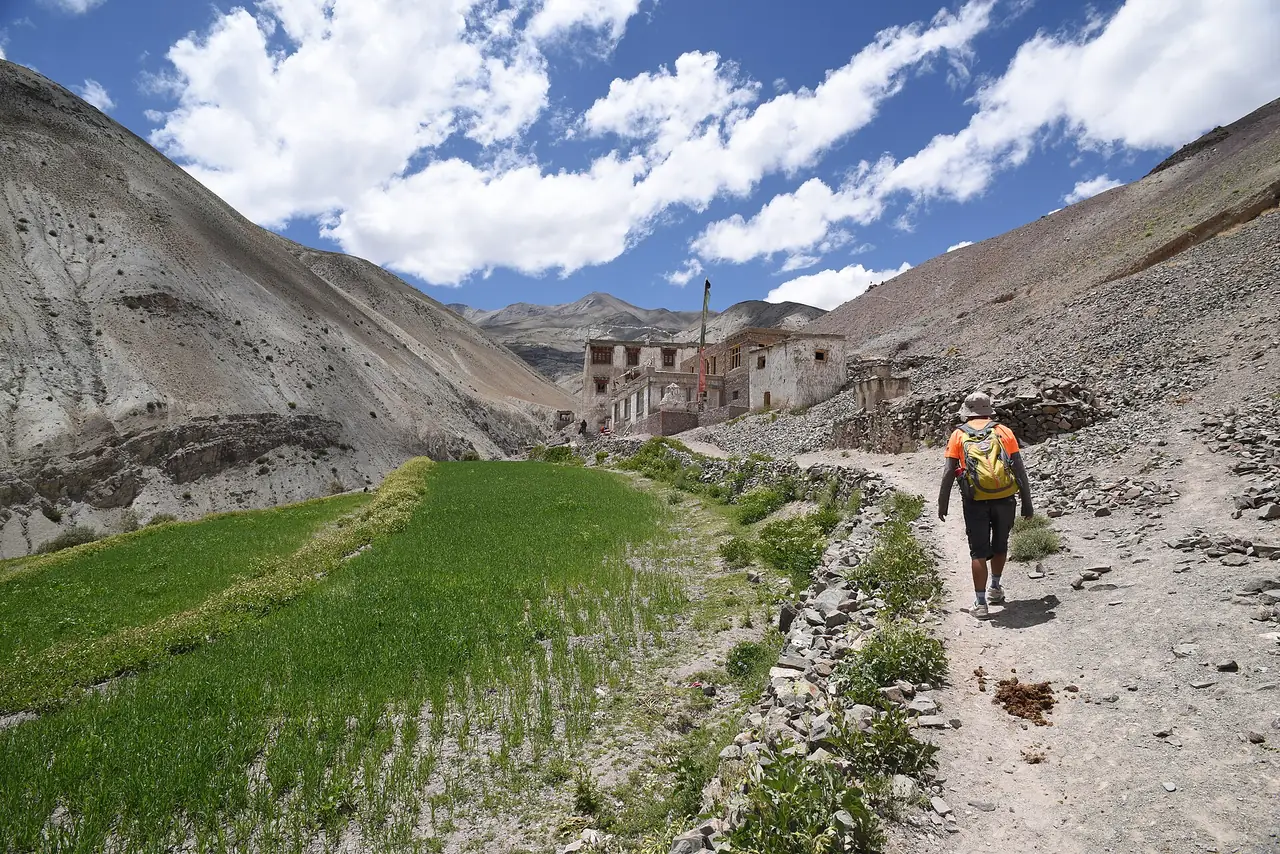 A trekker approaching a village in Ladakh
